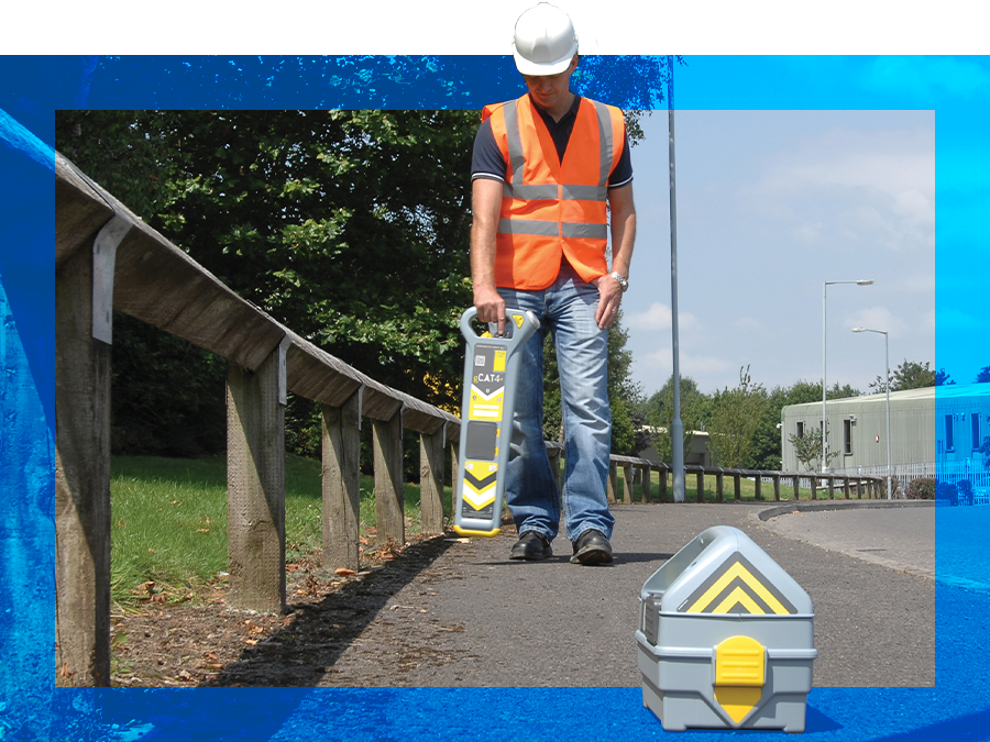 field worker using C.A.T4. and Genny transmitter on urban street