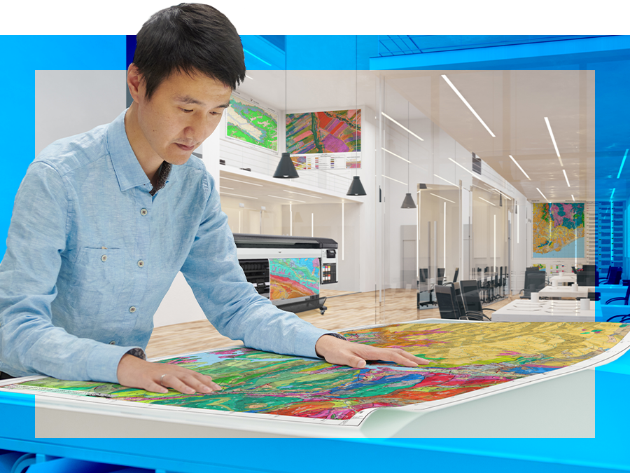 man reading wide format map on table