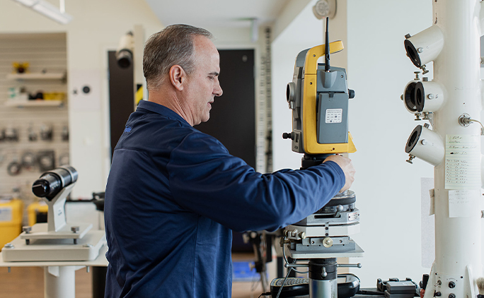 technician calibrating total station unit