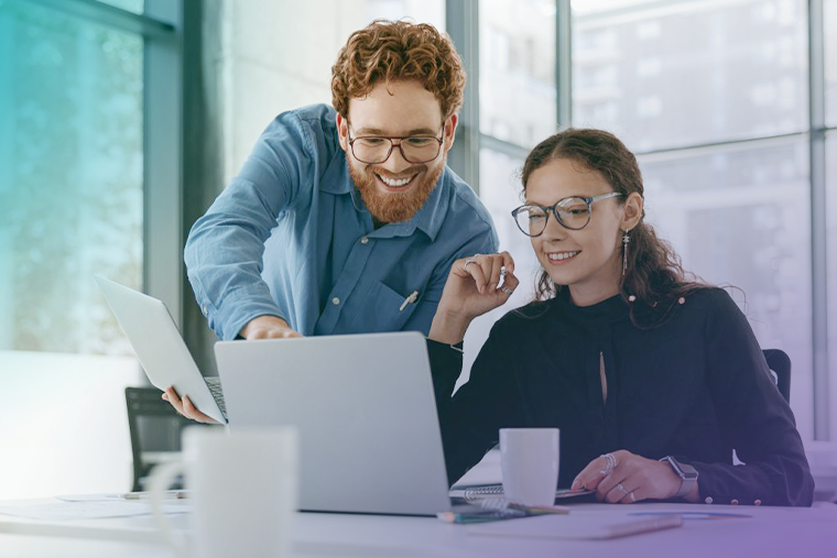 two young professionals looking at laptop